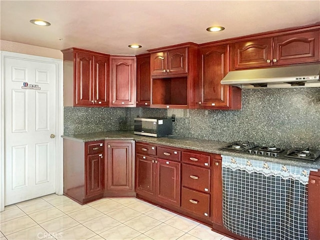 3855 Gilman Rd, El Monte, CA 91732 - kitchen with under cabinet range hood, stainless steel microwave, gas cooktop, dark brown cabinets, and recessed lighting