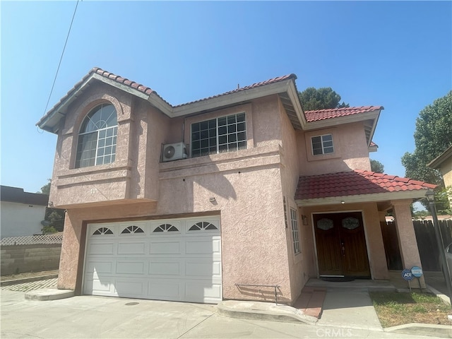 3855 Gilman Rd, El Monte, CA 91732 - view of front facade with stucco siding, a tiled roof, a garage, concrete driveway, and a cooling unit
