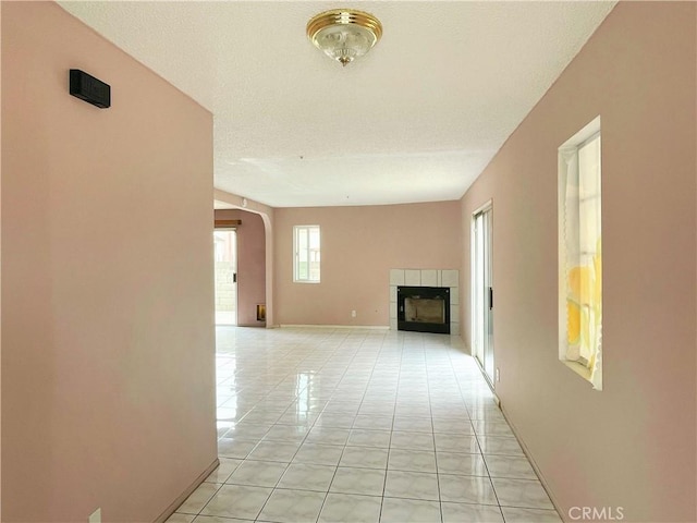 3855 Gilman Rd, El Monte, CA 91732 - hall featuring arched walkways, light tile patterned floors, and baseboards
