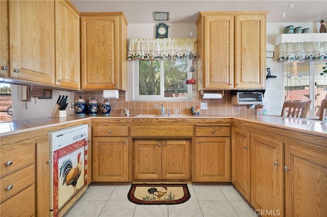 15506 Del Rey Dr, Victorville, CA 92395 - kitchen featuring tile countertops, white dishwasher, backsplash, and a sink