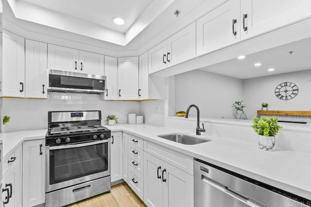 783 Brookstone Rd Unit 104, Chula Vista, CA 91913 - kitchen with stainless steel appliances, light countertops, white cabinets, recessed lighting, and backsplash