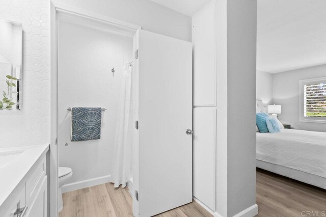 783 Brookstone Rd Unit 104, Chula Vista, CA 91913 - bathroom with wood finished floors, vanity, and a shower with curtain