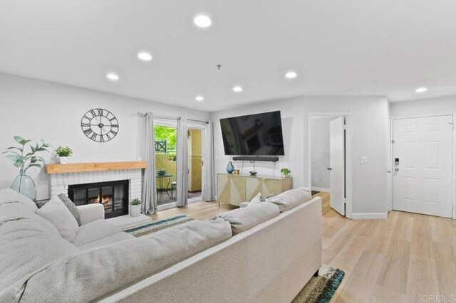 783 Brookstone Rd Unit 104, Chula Vista, CA 91913 - living room featuring recessed lighting, a brick fireplace, and light wood-style flooring