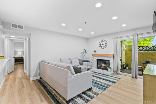 783 Brookstone Rd Unit 104, Chula Vista, CA 91913 - living area with light wood-style flooring, recessed lighting, and a brick fireplace