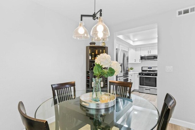 783 Brookstone Rd Unit 104, Chula Vista, CA 91913 - dining space with a raised ceiling, light wood finished floors, and recessed lighting