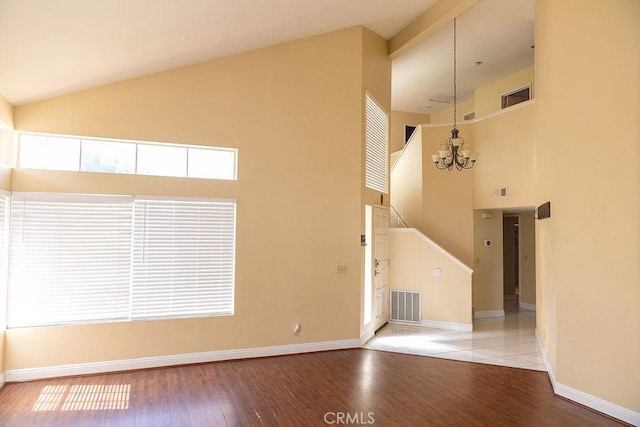 27474 Bolandra Ct, Temecula, CA 92591 - unfurnished living room featuring high vaulted ceiling, wood finished floors, and a chandelier
