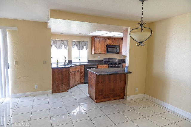 27474 Bolandra Ct, Temecula, CA 92591 - kitchen featuring black microwave, stainless steel range with gas stovetop, dark countertops, brown cabinets, and a peninsula