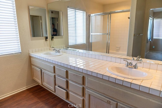 27474 Bolandra Ct, Temecula, CA 92591 - bathroom with a shower with door, double vanity, and wood finished floors