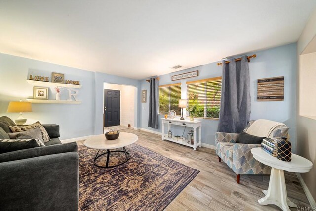 1064 Eliot St, Oceanside, CA 92057 - living area with wood finished floors and baseboards