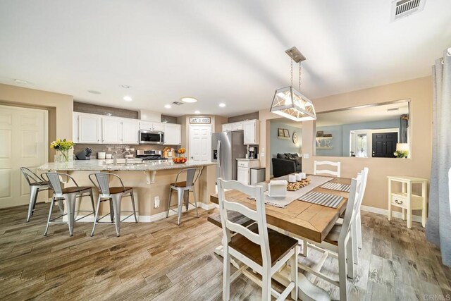 1064 Eliot St, Oceanside, CA 92057 - dining room with light wood-style flooring and recessed lighting