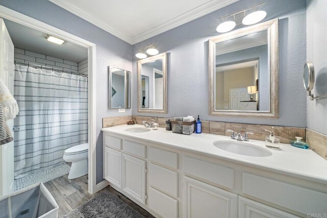 1064 Eliot St, Oceanside, CA 92057 - bathroom with double vanity, ornamental molding, wood finished floors, and curtained shower