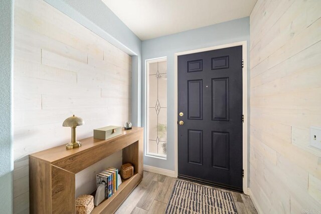 1064 Eliot St, Oceanside, CA 92057 - entryway with light wood-type flooring and wood walls