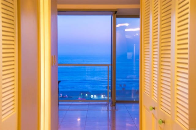 1200 N Harbor Dr Unit 15B, Oceanside, CA 92054 - hallway with tile patterned flooring and a water view