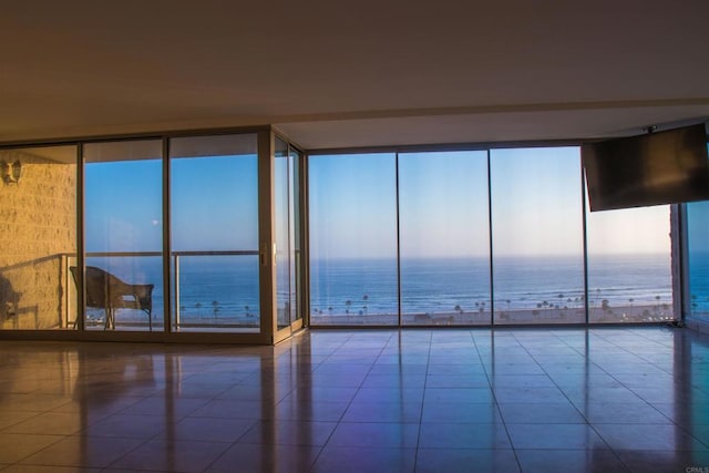 1200 N Harbor Dr Unit 15B, Oceanside, CA 92054 - empty room with floor to ceiling windows, a water view, tile patterned floors, and healthy amount of natural light
