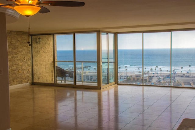 1200 N Harbor Dr Unit 15B, Oceanside, CA 92054 - tiled empty room with expansive windows, a water view, and ceiling fan