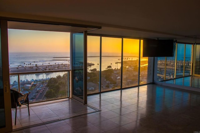 1200 N Harbor Dr Unit 15B, Oceanside, CA 92054 - empty room featuring expansive windows, a water view, and tile patterned floors