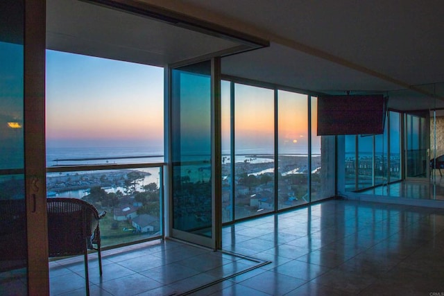 1200 N Harbor Dr Unit 15B, Oceanside, CA 92054 - spare room with a wall of windows, a water view, and tile patterned floors