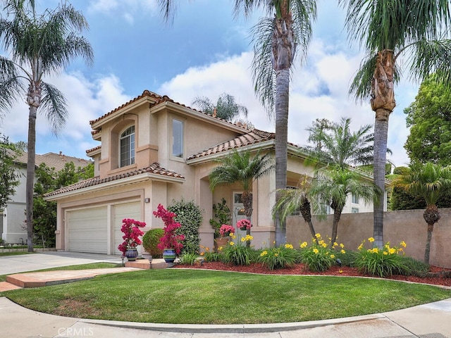 28 Covington, Mission Viejo, CA 92692 - mediterranean / spanish-style house featuring a tiled roof, an attached garage, stucco siding, and driveway