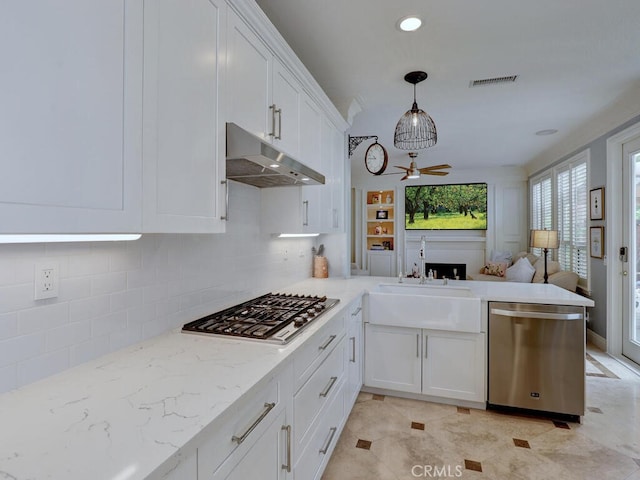 28 Covington, Mission Viejo, CA 92692 - kitchen featuring appliances with stainless steel finishes, under cabinet range hood, a ceiling fan, open floor plan, and tasteful backsplash
