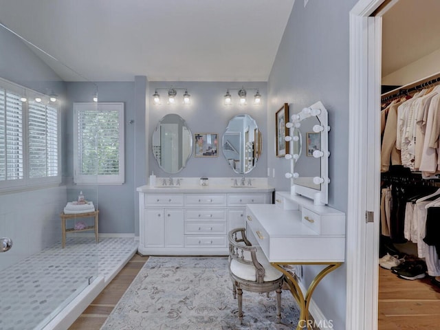 28 Covington, Mission Viejo, CA 92692 - full bath featuring wood finished floors, double vanity, lofted ceiling, and a walk in closet