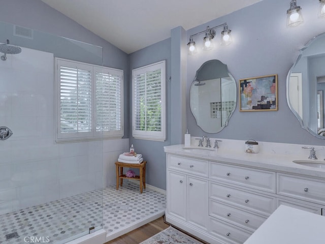 28 Covington, Mission Viejo, CA 92692 - bathroom with a tile shower, wood finished floors, double vanity, and lofted ceiling