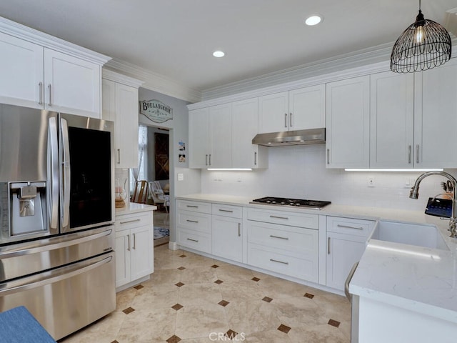28 Covington, Mission Viejo, CA 92692 - kitchen with appliances with stainless steel finishes, white cabinetry, under cabinet range hood, pendant lighting, and ornamental molding
