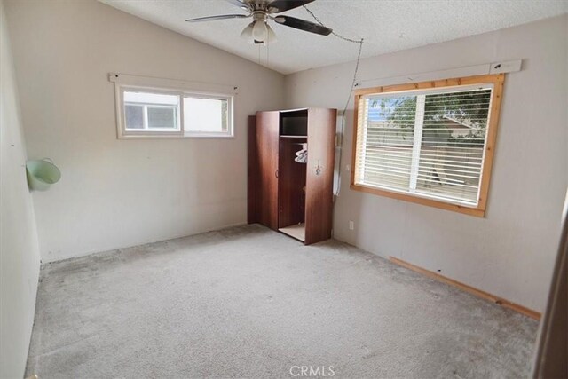 44037 Heaton Ave, Lancaster, CA 93534 - unfurnished bedroom with carpet flooring, lofted ceiling, a textured ceiling, and ceiling fan