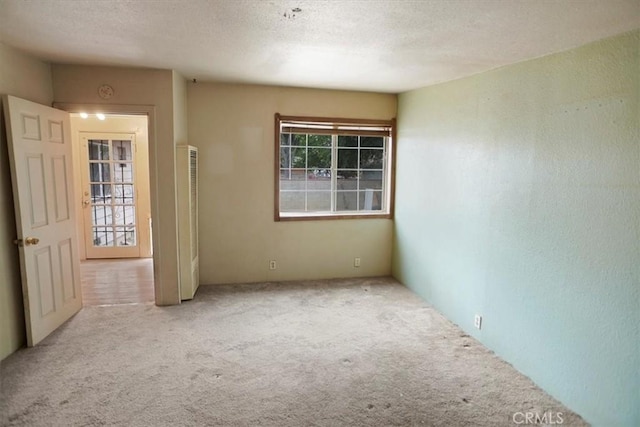 44037 Heaton Ave, Lancaster, CA 93534 - spare room with carpet floors, a heating unit, a textured ceiling, and a textured wall