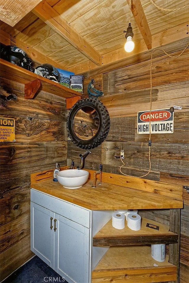 7912 Royce Ave, Hesperia, CA 92345 - bathroom featuring wood ceiling with exposed beams, vanity, and wooden walls
