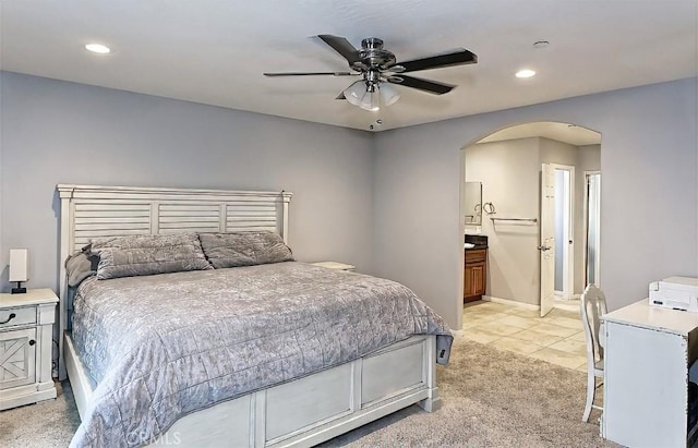 7912 Royce Ave, Hesperia, CA 92345 - bedroom featuring arched walkways, light carpet, recessed lighting, light tile patterned flooring, and connected bathroom