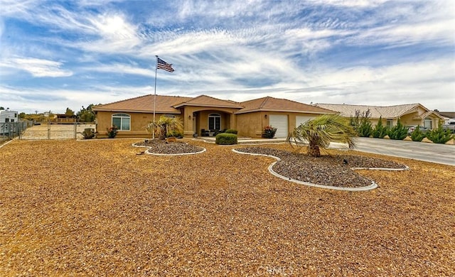 7912 Royce Ave, Hesperia, CA 92345 - view of front facade with concrete driveway, a garage, and stucco siding