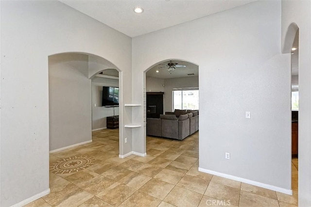 7912 Royce Ave, Hesperia, CA 92345 - unfurnished room featuring a ceiling fan, arched walkways, baseboards, and recessed lighting