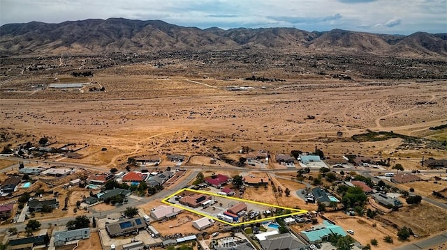 7912 Royce Ave, Hesperia, CA 92345 - aerial overview of property's location with property parcel outlined, a mountain backdrop, and a desert landscape