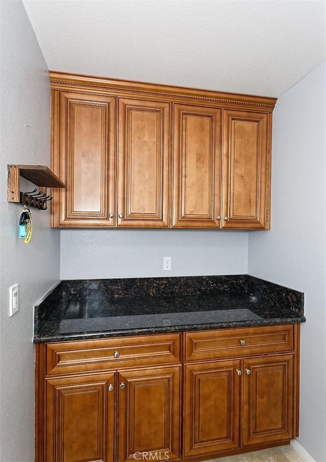 7912 Royce Ave, Hesperia, CA 92345 - kitchen with brown cabinets and dark stone countertops