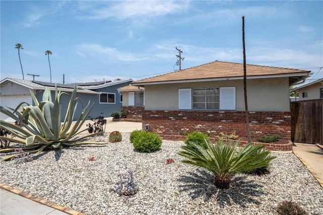 1139 W 149th St, Gardena, CA 90247 - view of front of property with stucco siding, roof mounted solar panels, and brick siding