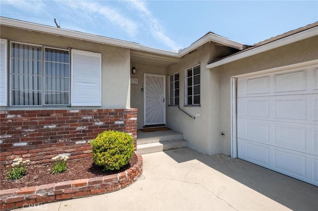 1139 W 149th St, Gardena, CA 90247 - entrance to property with a garage, stucco siding, driveway, and brick siding