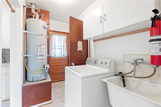 1139 W 149th St, Gardena, CA 90247 - laundry area with washer / clothes dryer, secured water heater, cabinet space, and light wood finished floors