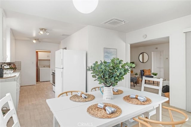 1139 W 149th St, Gardena, CA 90247 - dining area with washer / clothes dryer and light wood finished floors