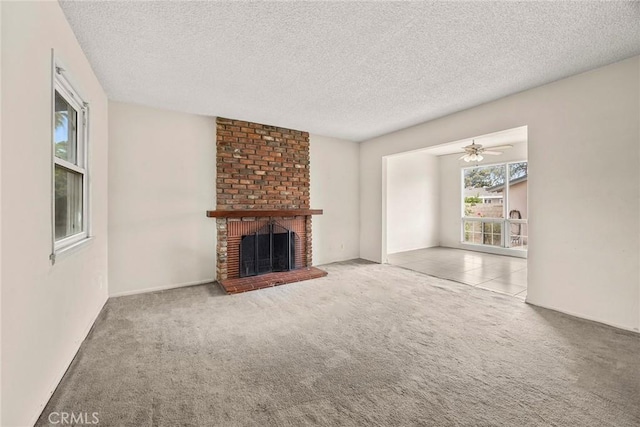 1208 E Commonwealth Ave, Fullerton, CA 92831 - unfurnished living room featuring carpet floors, a textured ceiling, a fireplace, and a ceiling fan