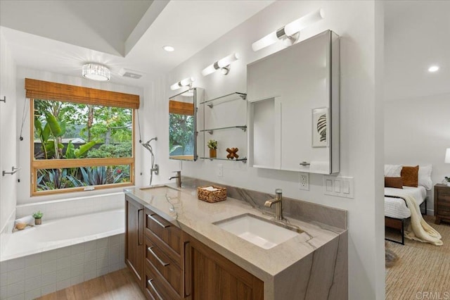 3995 Cypress Del Mar, San Diego, CA 92130 - ensuite bathroom with double vanity, a relaxing tiled tub, recessed lighting, and wood finished floors