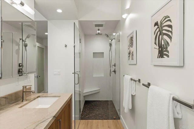 3995 Cypress Del Mar, San Diego, CA 92130 - bathroom with a stall shower, vanity, and wood finished floors