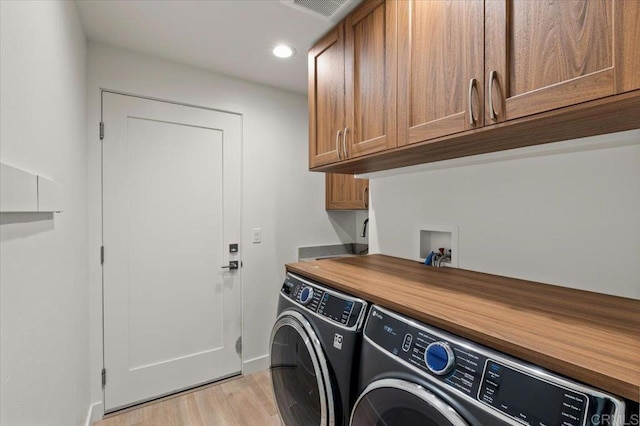 3995 Cypress Del Mar, San Diego, CA 92130 - laundry area with cabinet space, independent washer and dryer, light wood-style floors, recessed lighting, and baseboards