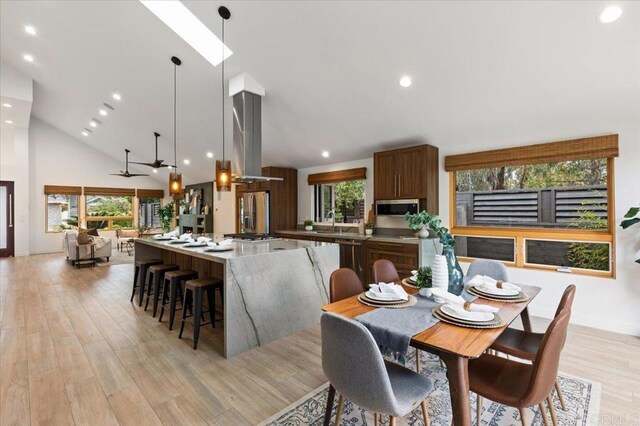3995 Cypress Del Mar, San Diego, CA 92130 - dining room featuring healthy amount of natural light, recessed lighting, light wood finished floors, high vaulted ceiling, and baseboards