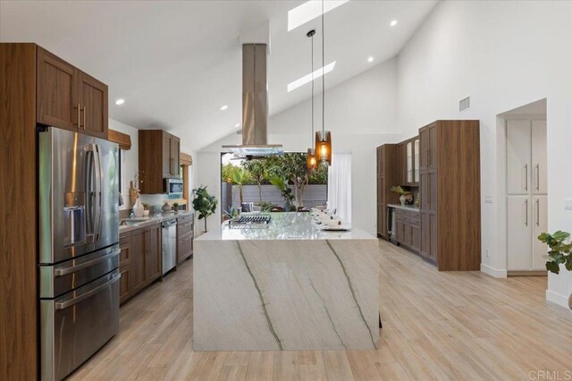 3995 Cypress Del Mar, San Diego, CA 92130 - kitchen featuring stainless steel appliances, a center island, light wood-style floors, light stone counters, and island range hood