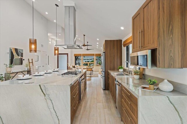 3995 Cypress Del Mar, San Diego, CA 92130 - kitchen with a sink, stainless steel appliances, a large island, brown cabinetry, and light wood-type flooring