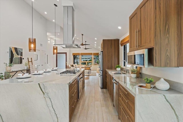 3995 Cypress Del Mar, San Diego, CA 92130 - kitchen featuring stainless steel appliances, brown cabinetry, a large island, light wood-style floors, and light stone counters