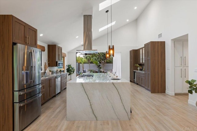 3995 Cypress Del Mar, San Diego, CA 92130 - kitchen with stainless steel appliances, island exhaust hood, a kitchen island, light wood-type flooring, and light stone counters