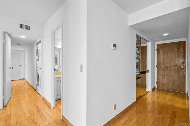 3635 7th Ave Unit 13E, San Diego, CA 92103 - corridor with stacked washer / drying machine, light wood-style flooring, baseboards, and recessed lighting