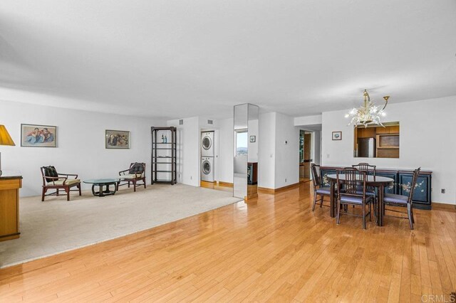 3635 7th Ave Unit 13E, San Diego, CA 92103 - dining room with stacked washer / dryer, a chandelier, and light wood finished floors