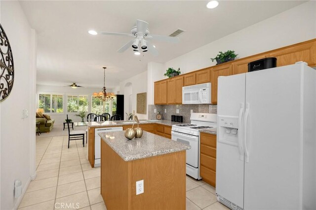 23820 Towish Dr, Corona, CA 92883 - kitchen featuring white appliances, ceiling fan, a peninsula, light tile patterned floors, and backsplash